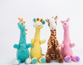 Musical plush toys - teal dragon, yellow giraffe, brown giraffe and pink unicorn