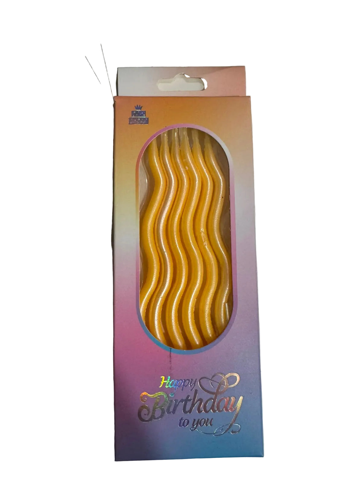 Packaged gold birthday candles on a white surface