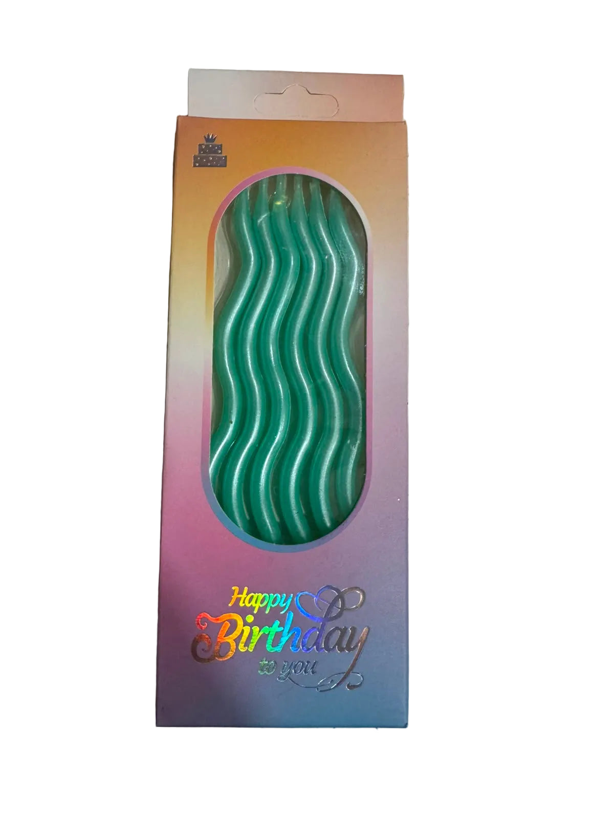 Green birthday candle in a decorative box with 'Happy Birthday' text on a light gray surface.
